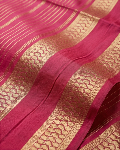 Close-up of pink border with gold patterns